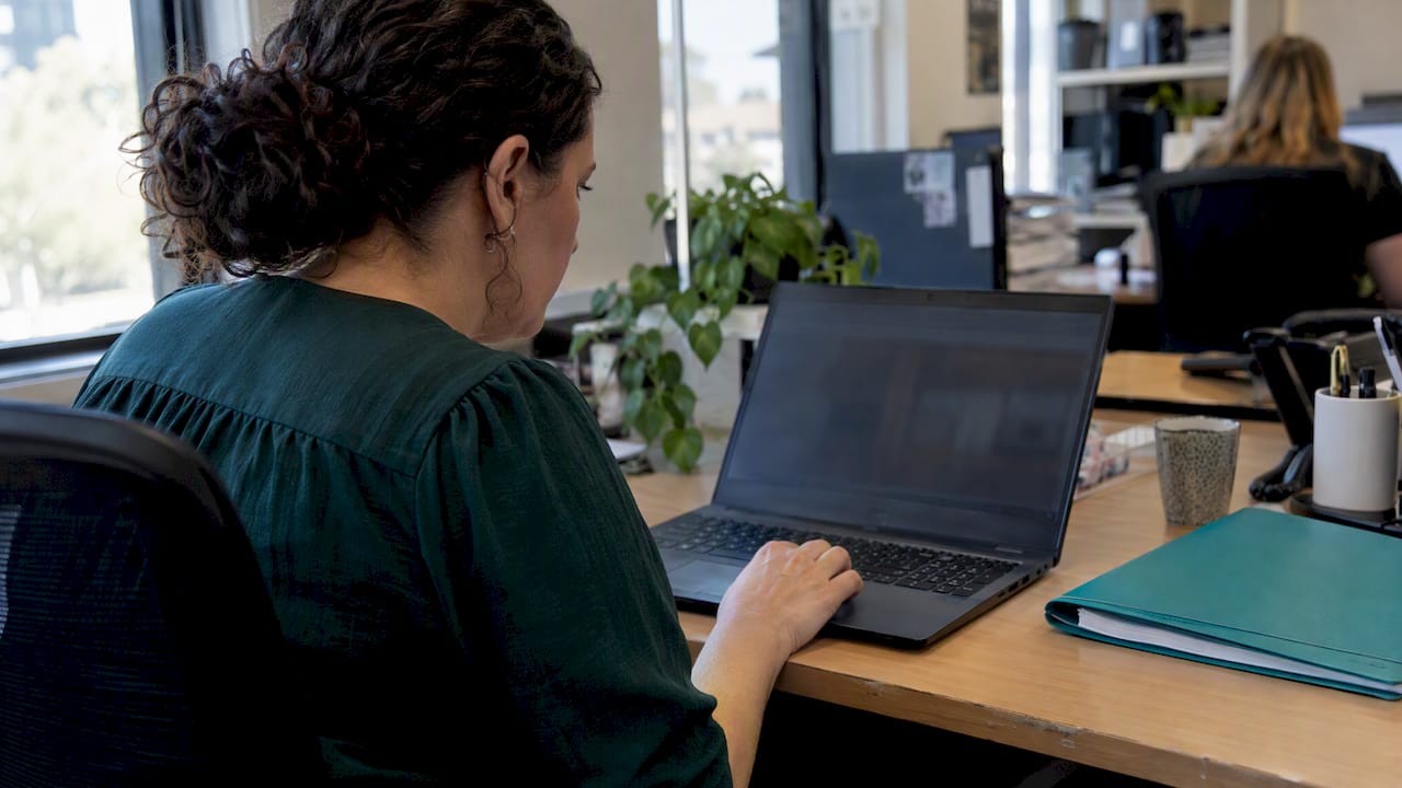 Officer reviewing updated AUSTRAC reporting forms