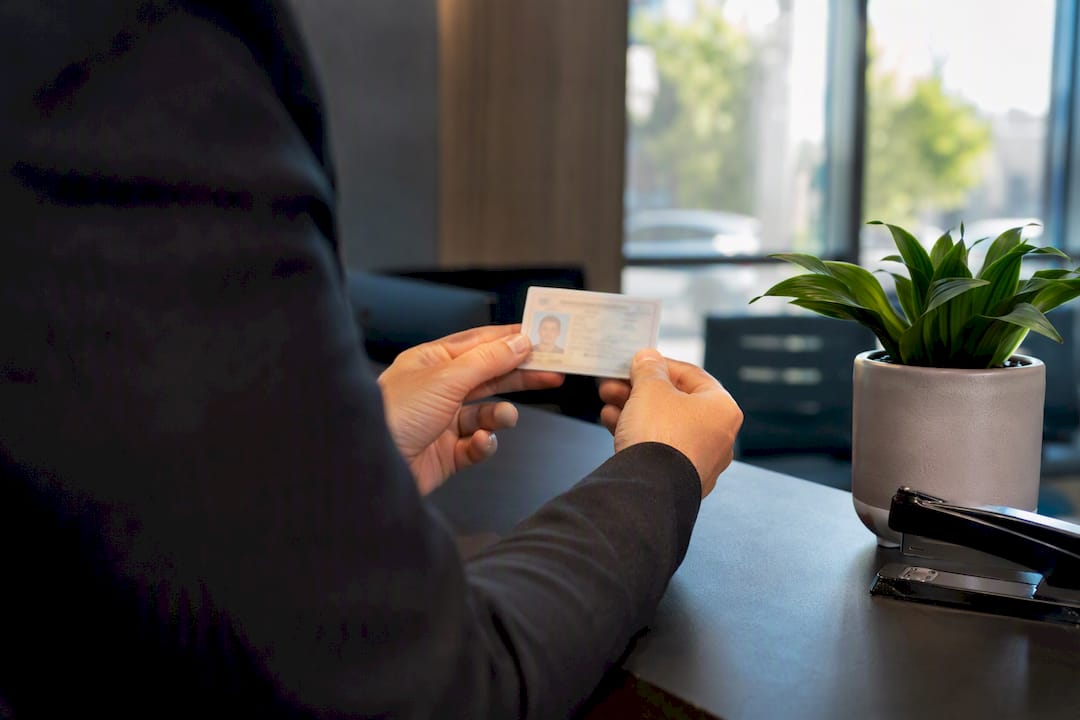 Hands scanning photo ID at real estate agency counter