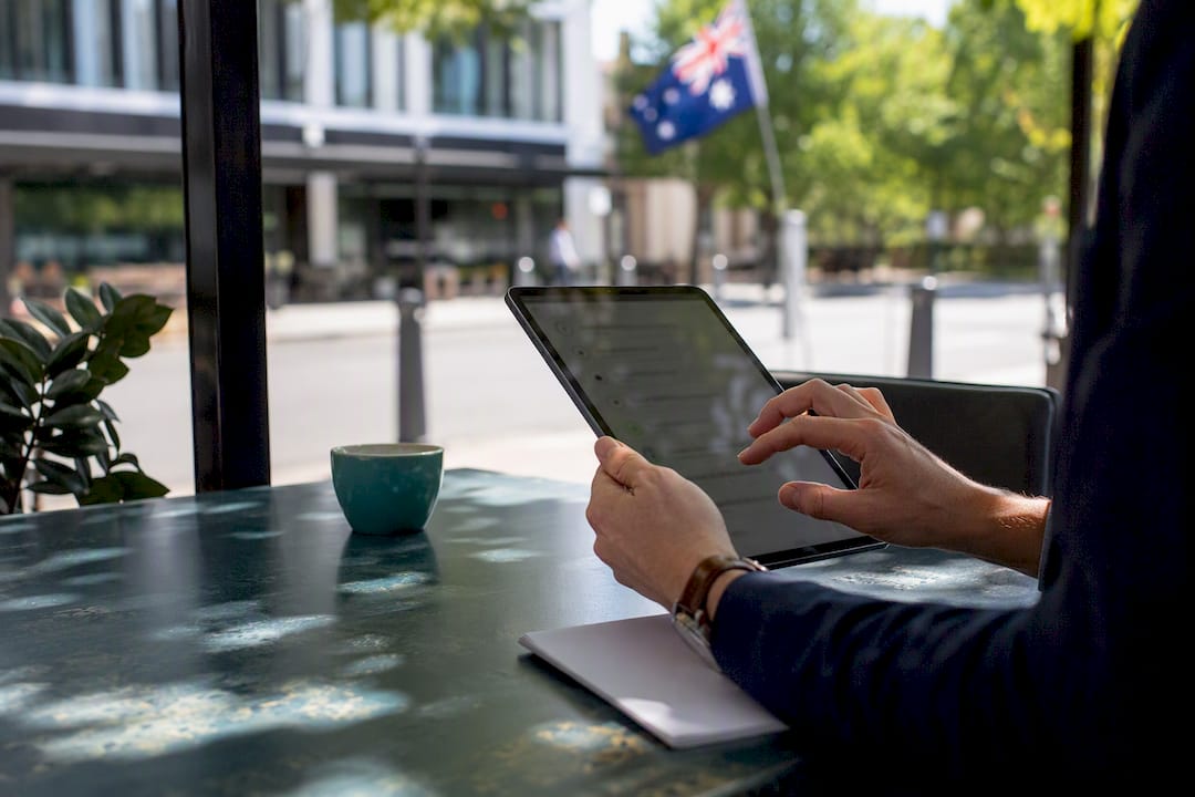 Hands holding tablet showing compliance checklist